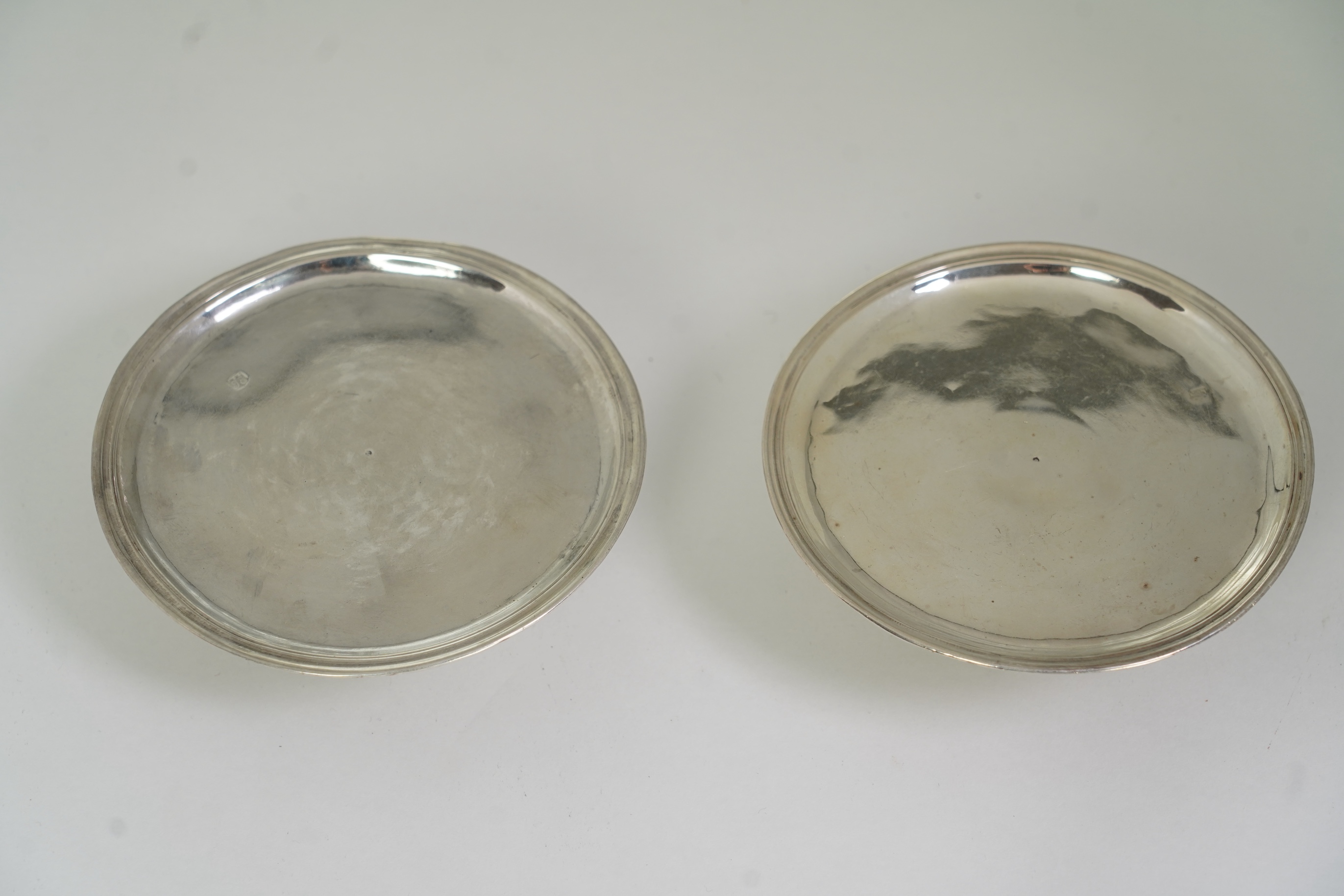 A pair of early late George I/early George II provincial silver patens, by John Elston Jnr